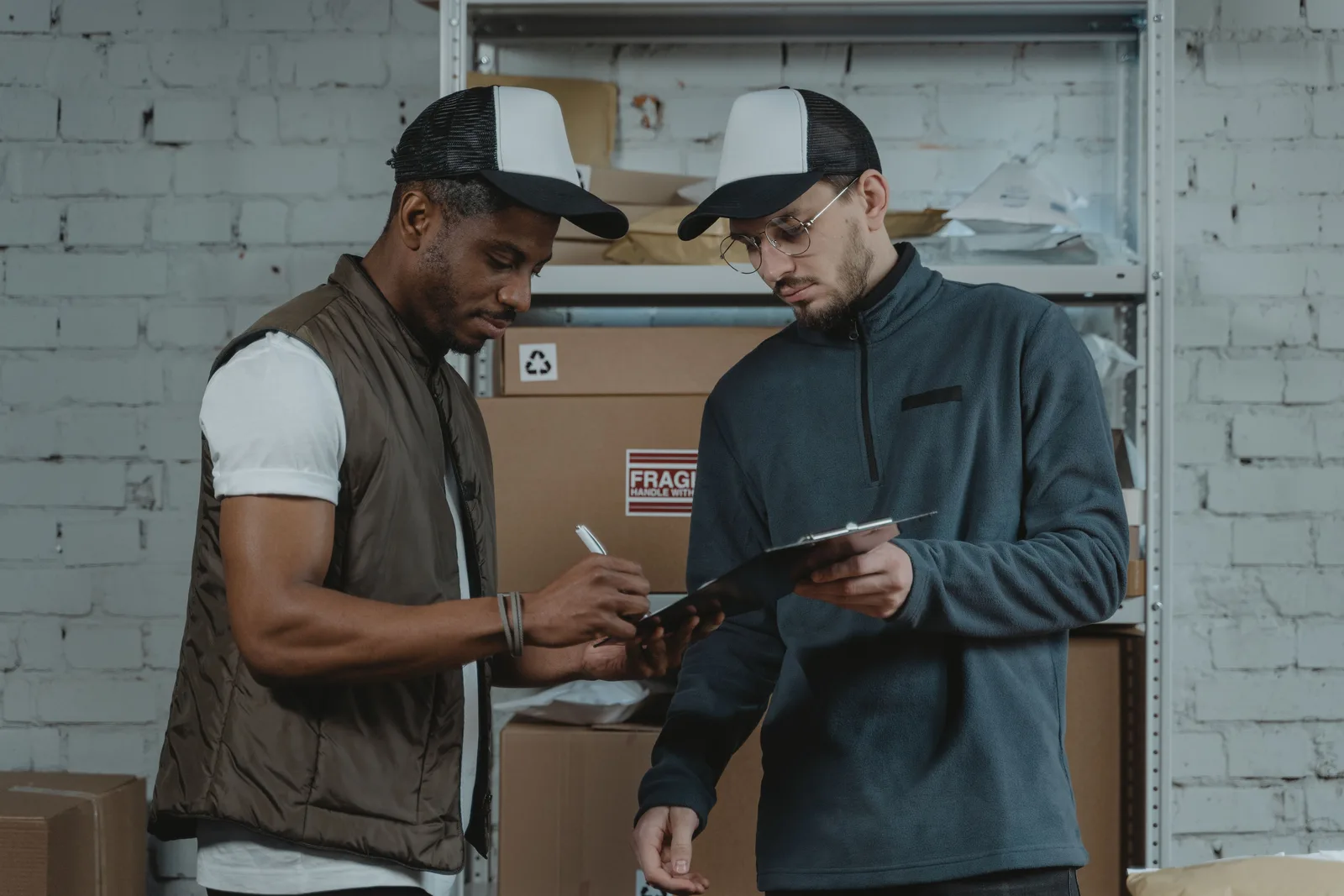 Warehouse coordinator checking delivery documents on a clipboard