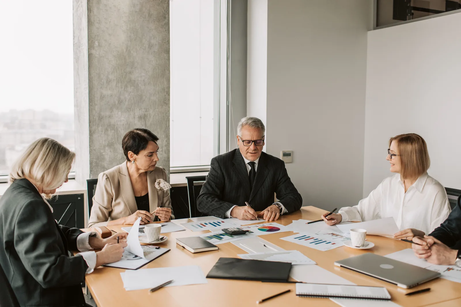 Commercial team reviewing programme requirements around a meeting table
