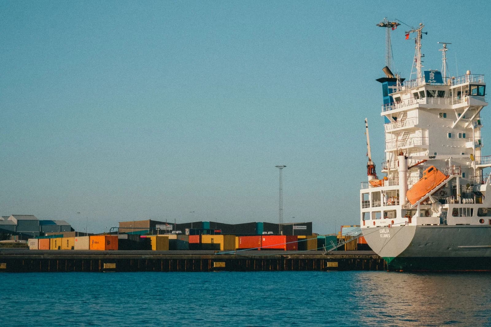 Cargo ship alongside a container terminal during dispatch coordination