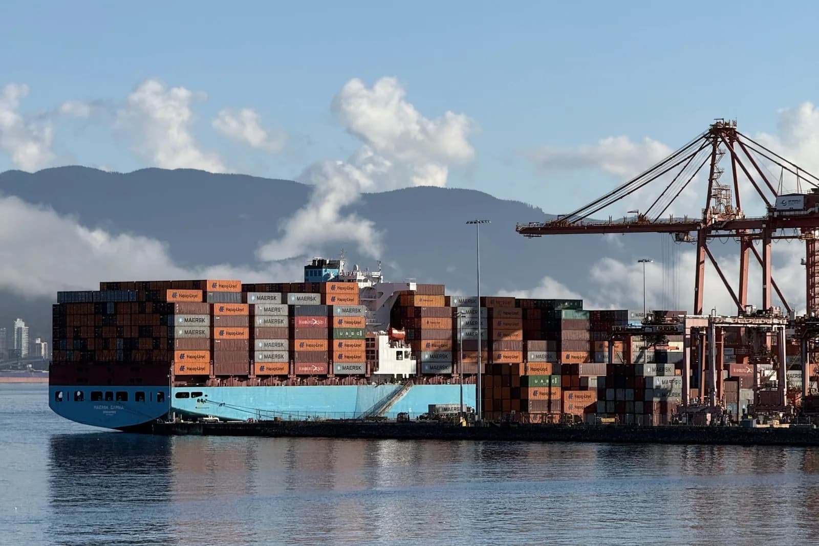 Cargo ship alongside a container terminal during shipment coordination
