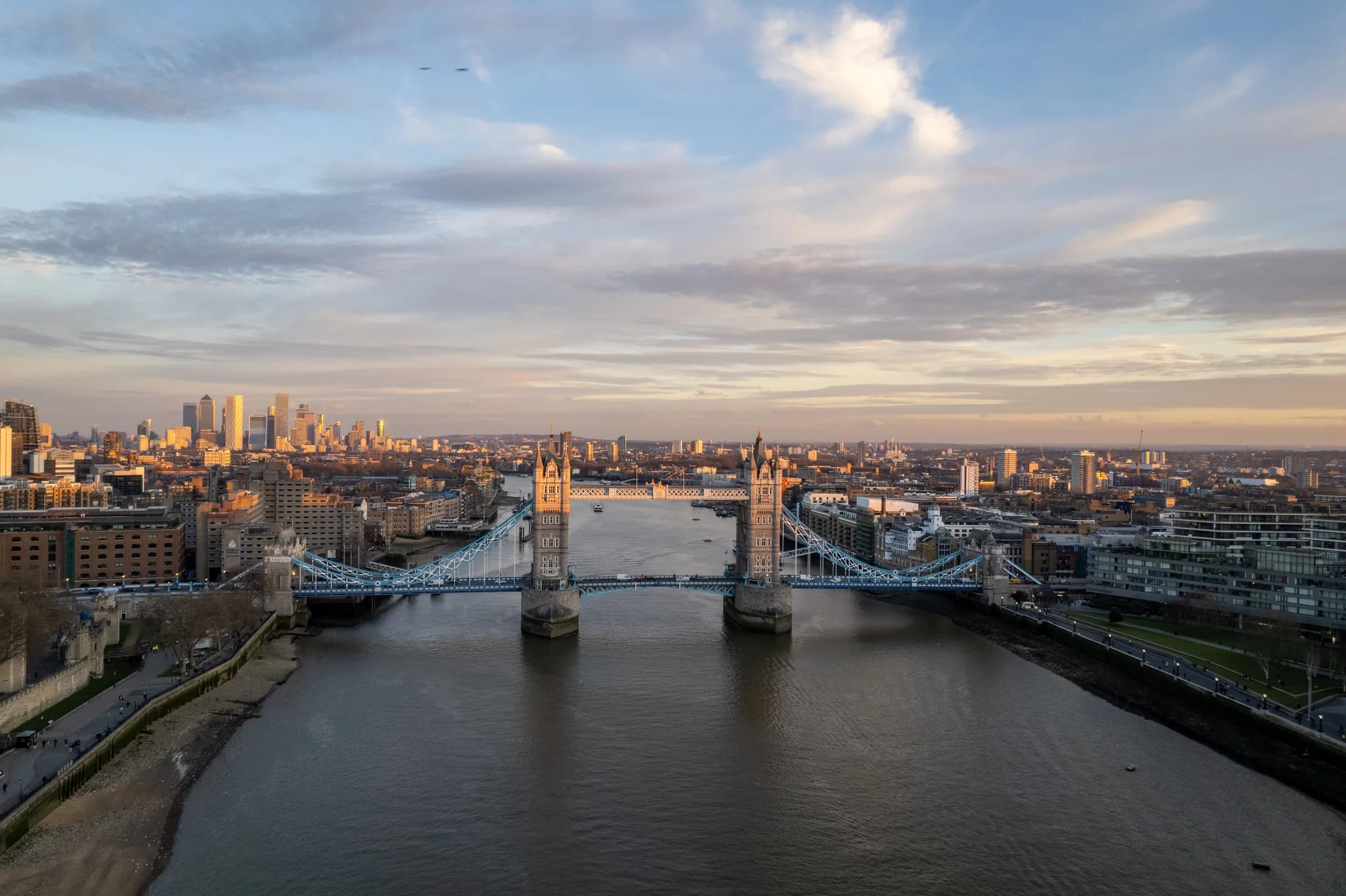Aerial view of Tower Bridge and the River Thames across the London skyline.
