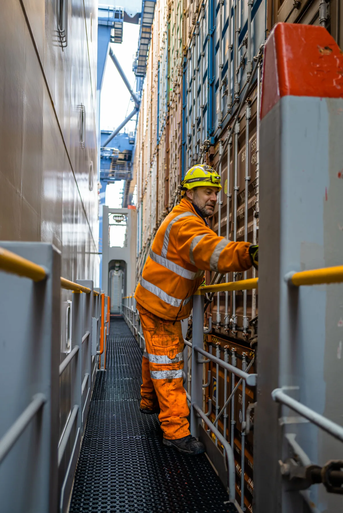 Port worker beside cargo containers at Felixstowe