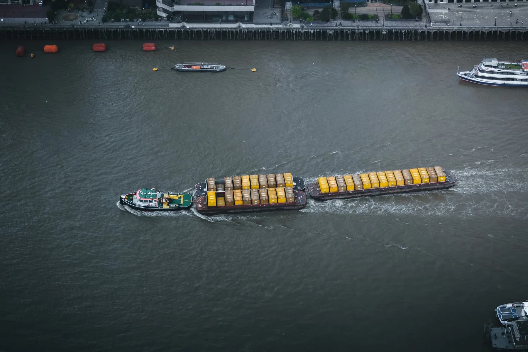Container barge moving along the River Thames in London