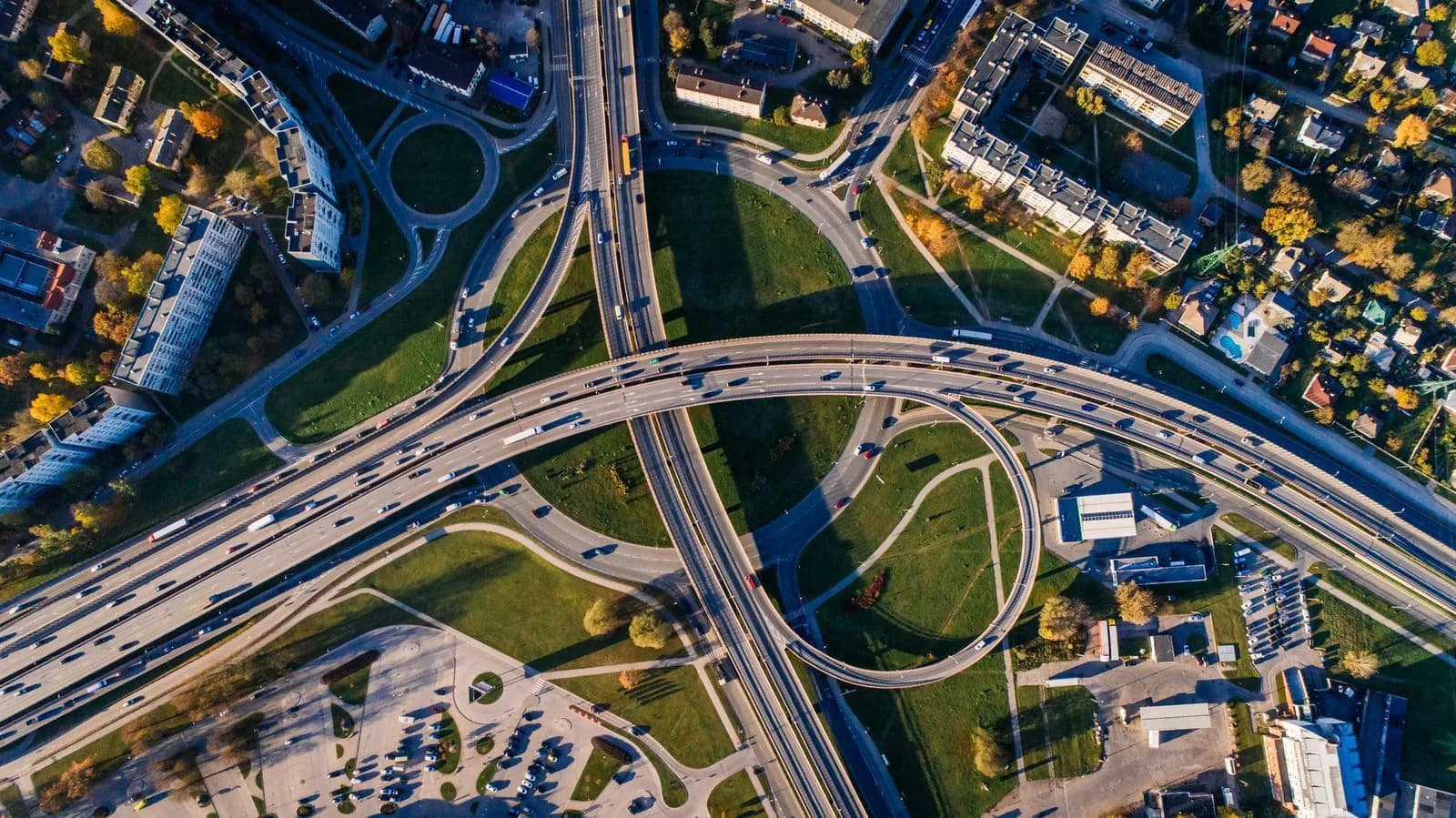 Aerial view of a multi-level urban road interchange and moving traffic