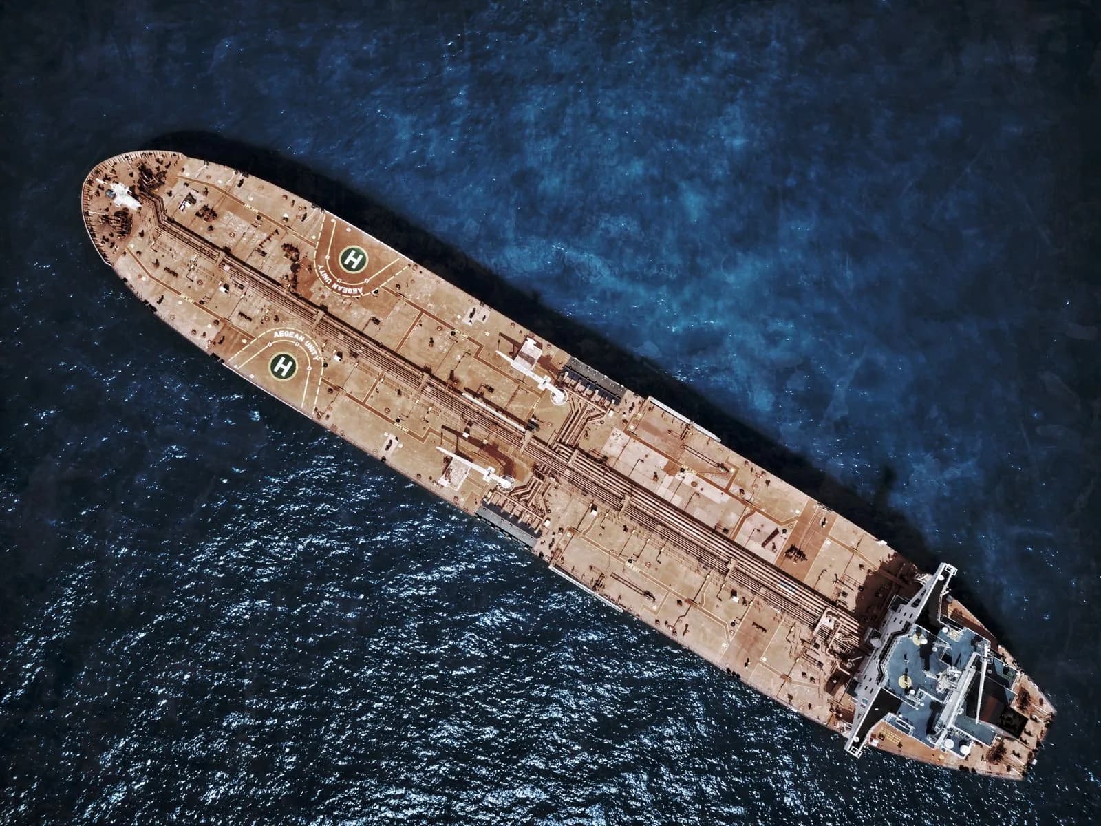 Aerial view of a tanker ship travelling across dark ocean water