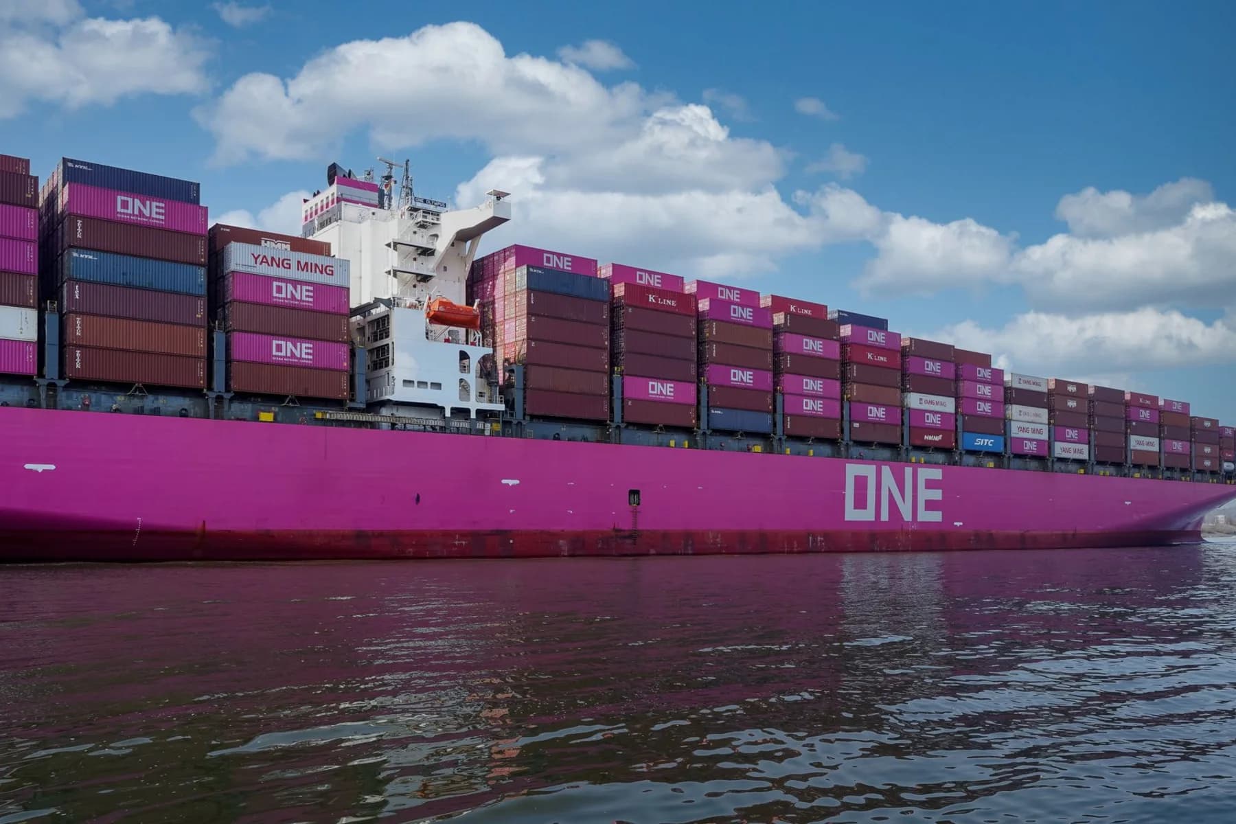 Colourful container ship moving through a European harbour