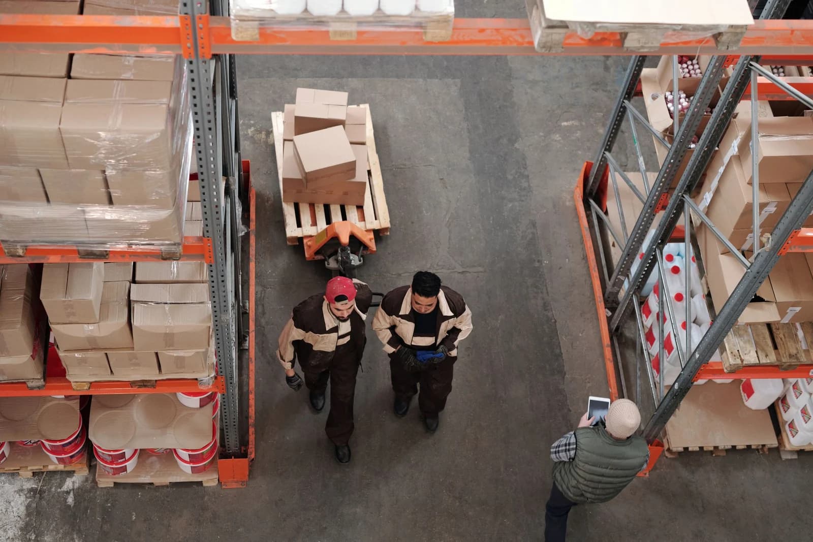 Warehouse team coordinating boxed goods and pallets